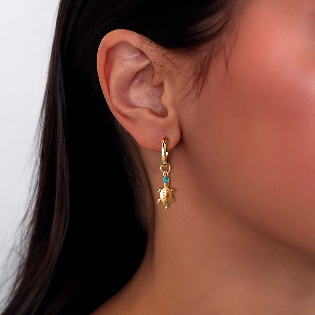 model wearing turtle charmed hoop earrings gold aquamarine