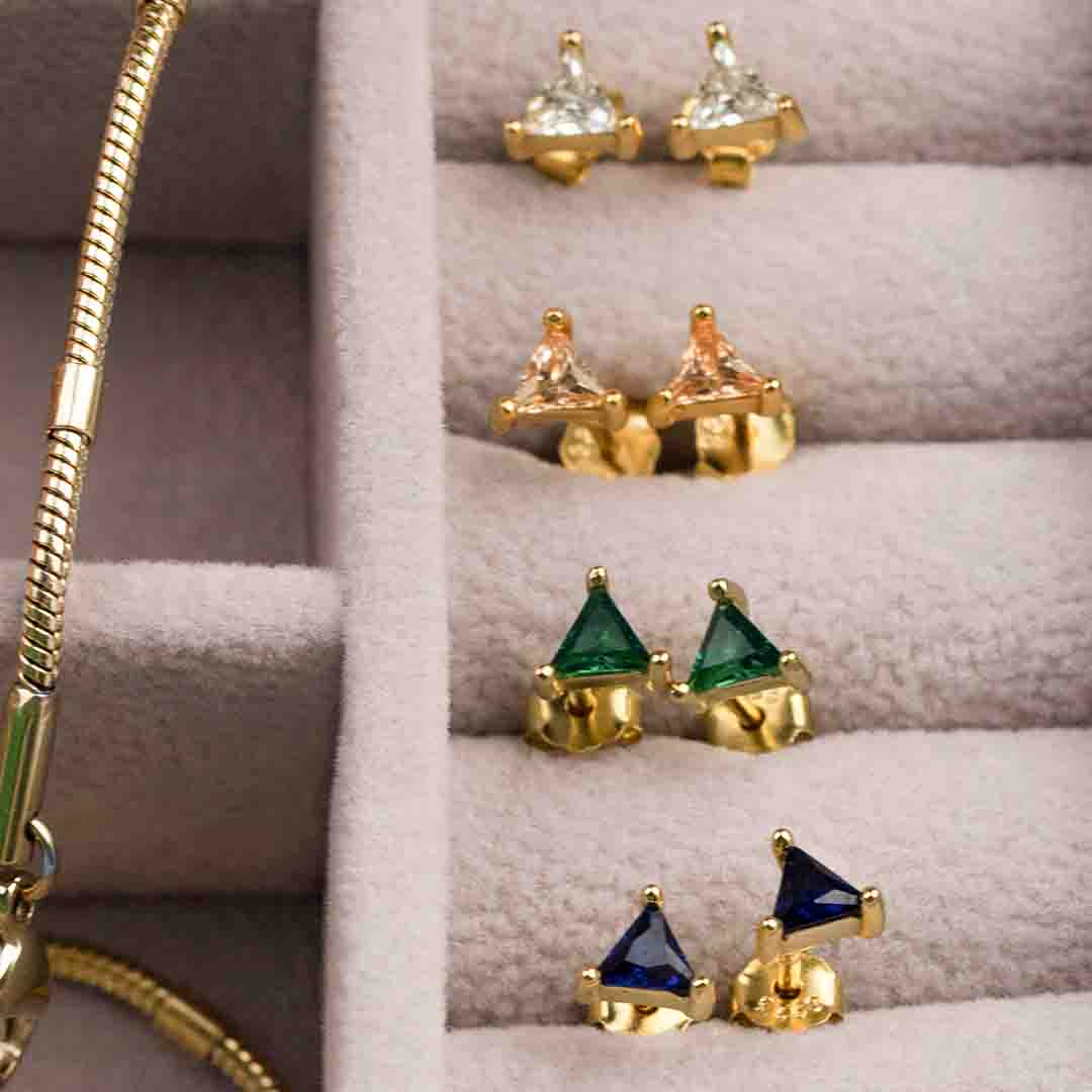 4 triangle gold stud earrings in travel case