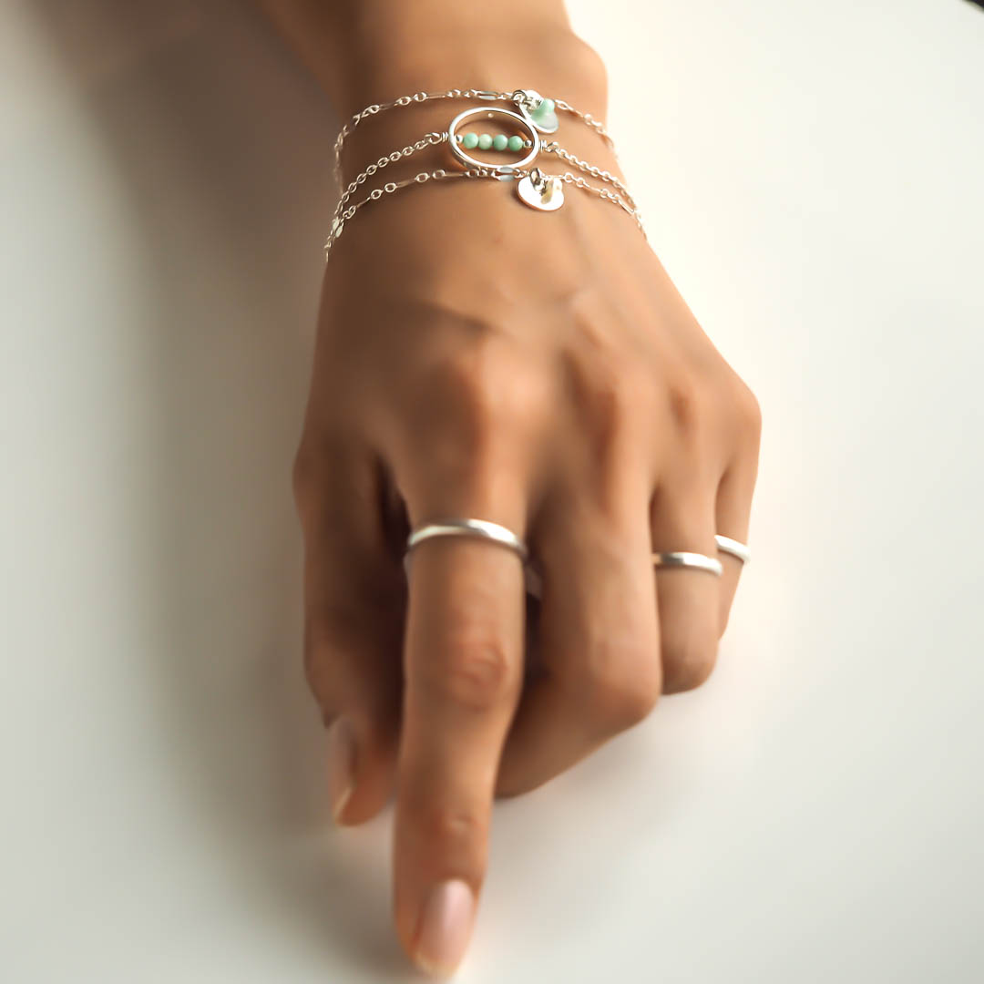 Hand model wearing Halo MOP and Unity  Bracelets Silver1
