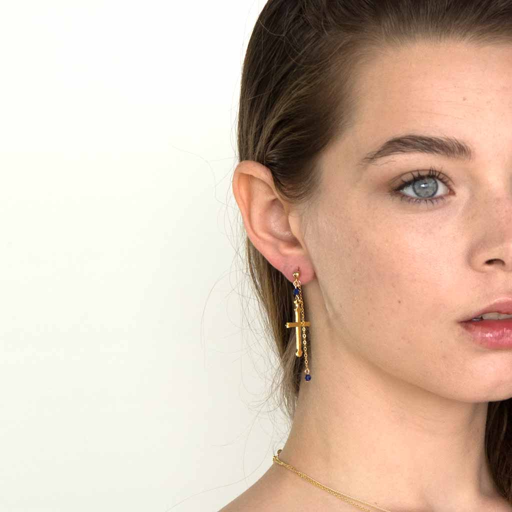 Model wearing Faith Cross Earrings Gold
