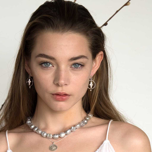 Model-wearing-Halo-Cross-Earrings-Pearl-and-Scorpio-Necklaces