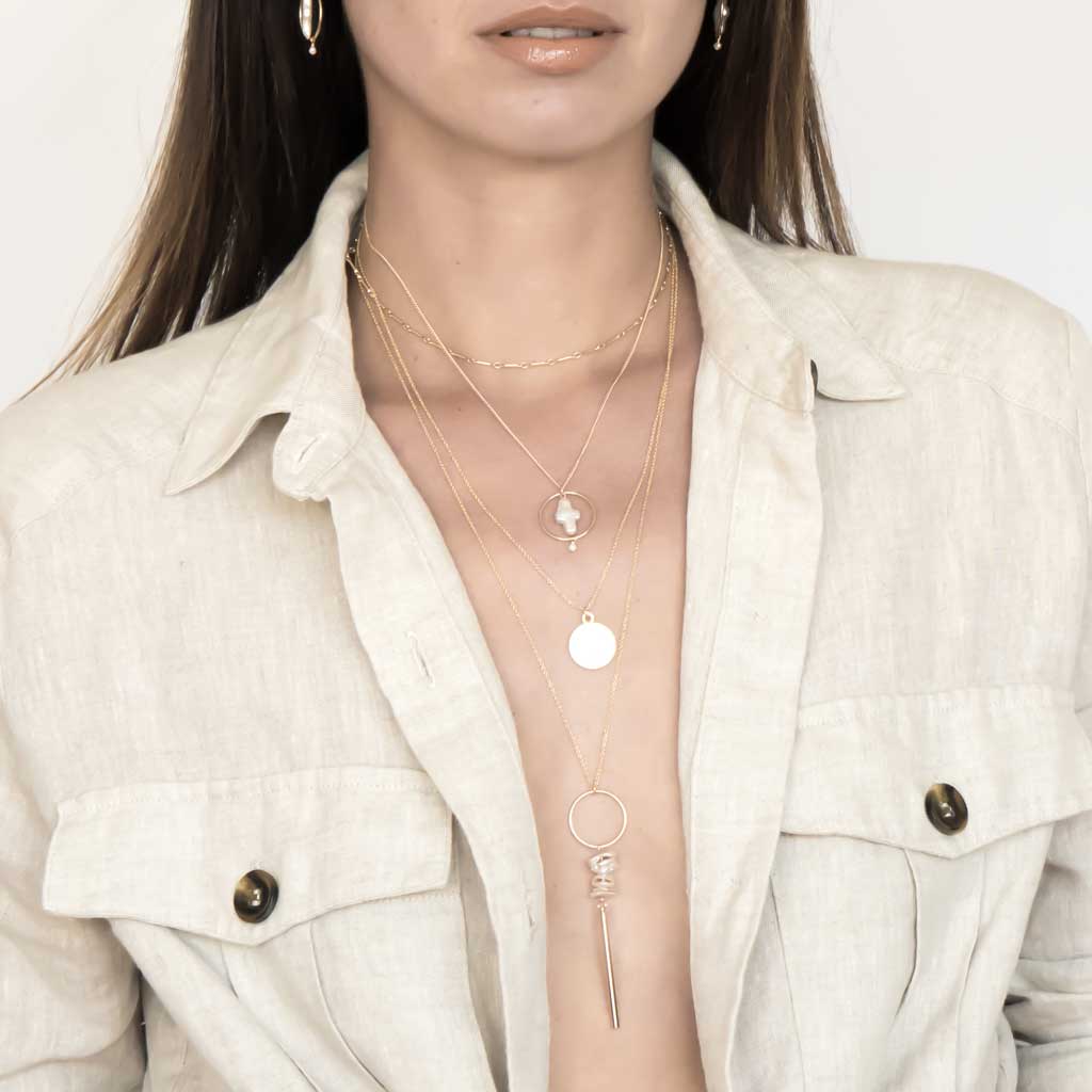 Model wearing Halo Cross and Keishi Bar necklaces styled