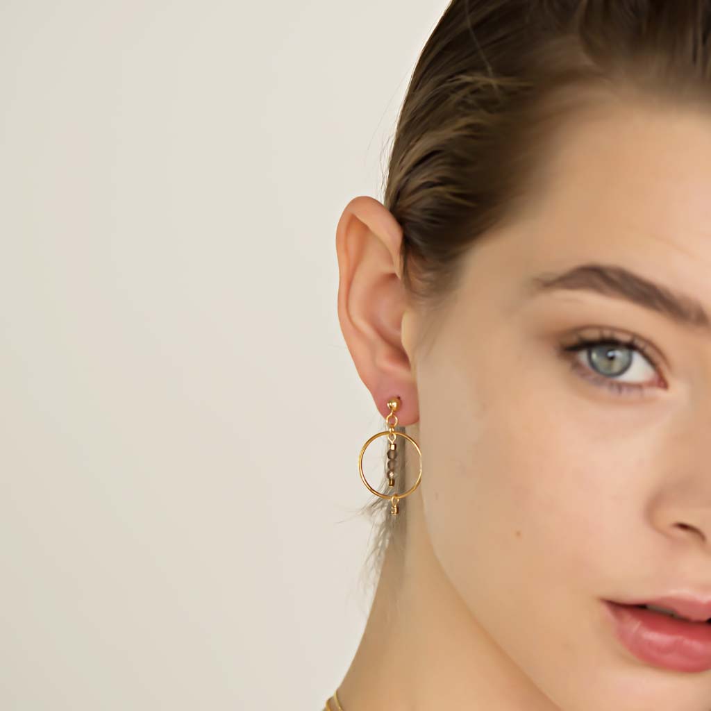 Model wearing Halo Equilibria Earrings - Gold and Smoky Quartz