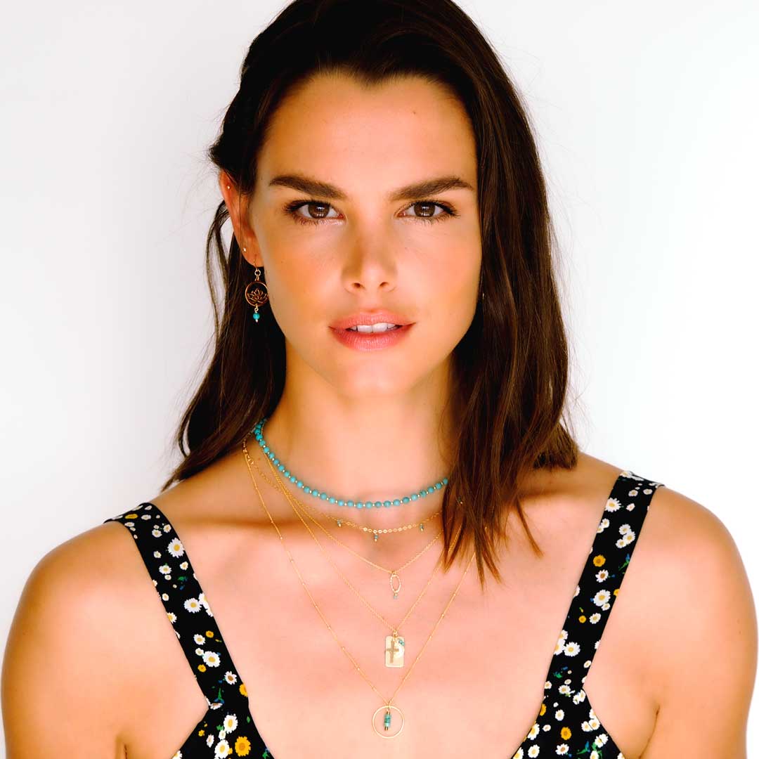 Model wearing Nefertiti necklace layered