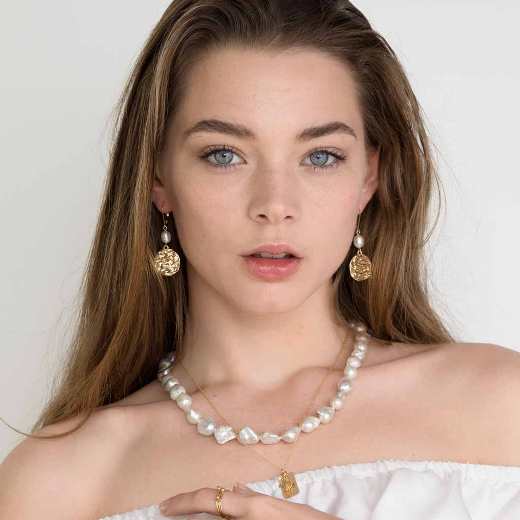 Model wearing Atlantis Pearl Drop Earrings - Gold and Pearl