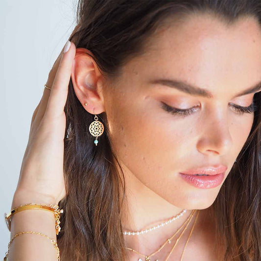 Model wearing Dandelion Hook earrings gold and amazonite