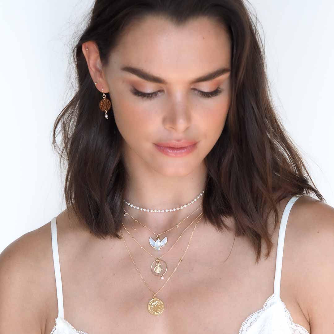 Model wearing Dove,Halo faith, heirloom gold coin necklaces,Dandelion earring gold and pearl