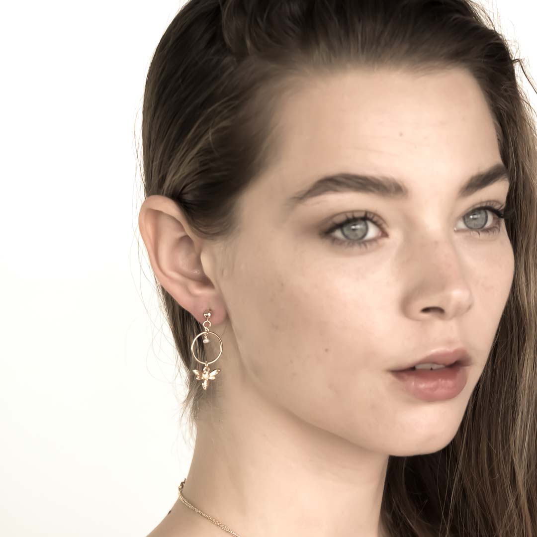 Model wearing Halo Honey Bee Earrings Gold and Pearl
