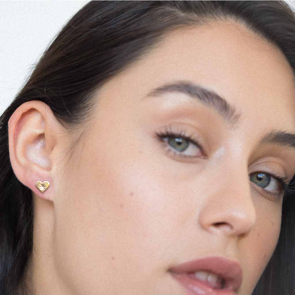 Model wearing Heartbeat stud earrings gold 