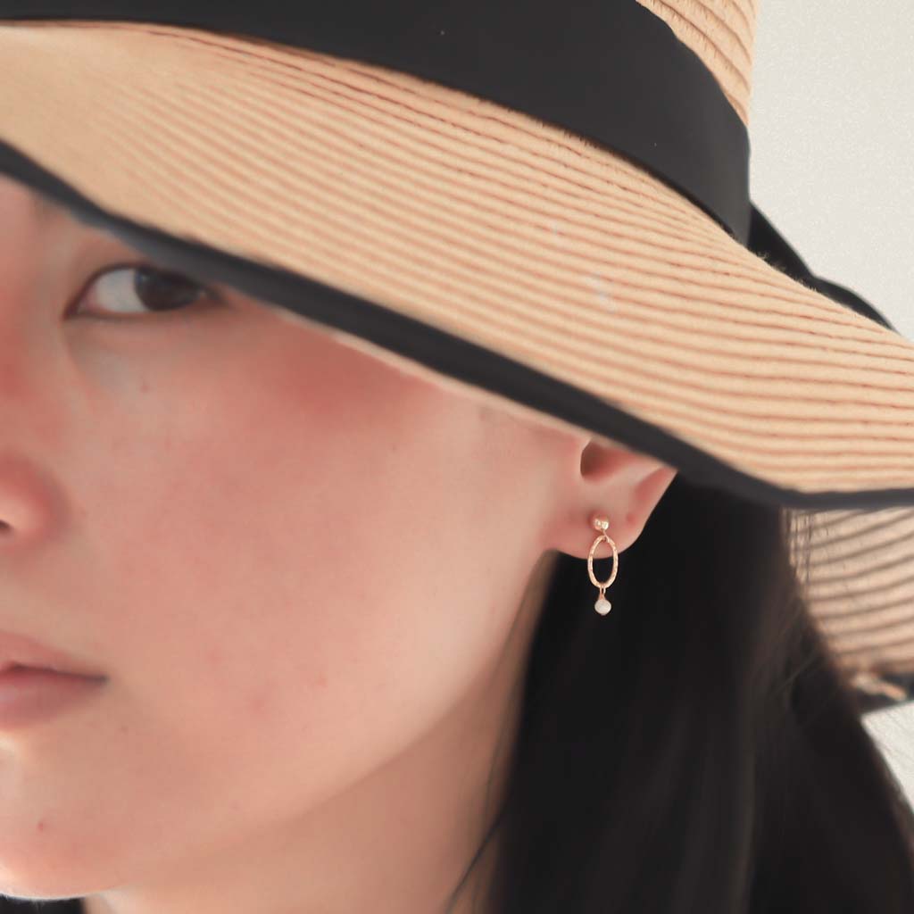 Model wearing Orbit Mini Earrings Gold and Pearl