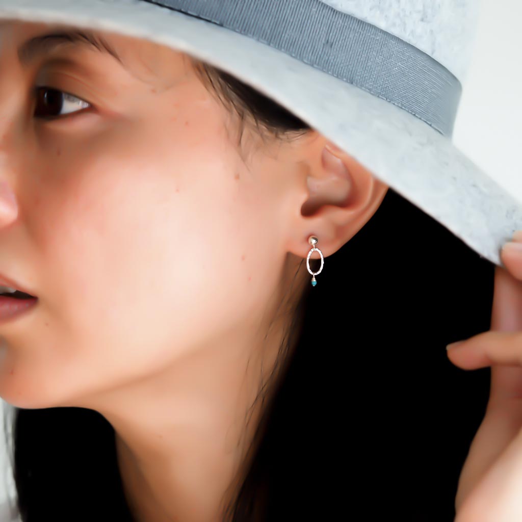 Model wearing Orbit Mini Earrings Silver and Turquoise