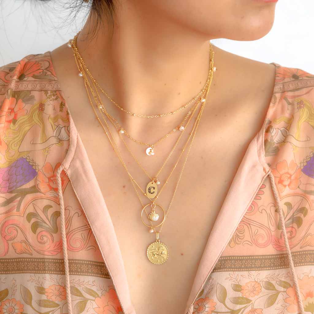 Model wearing Charmed Necklace layered