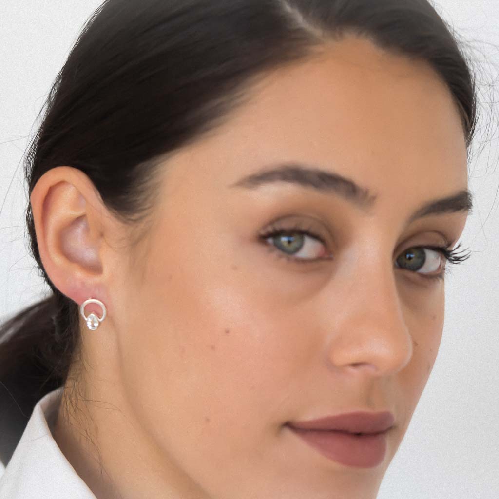 Model wearing Teardrop single ray earrings silver aquamarine 2 