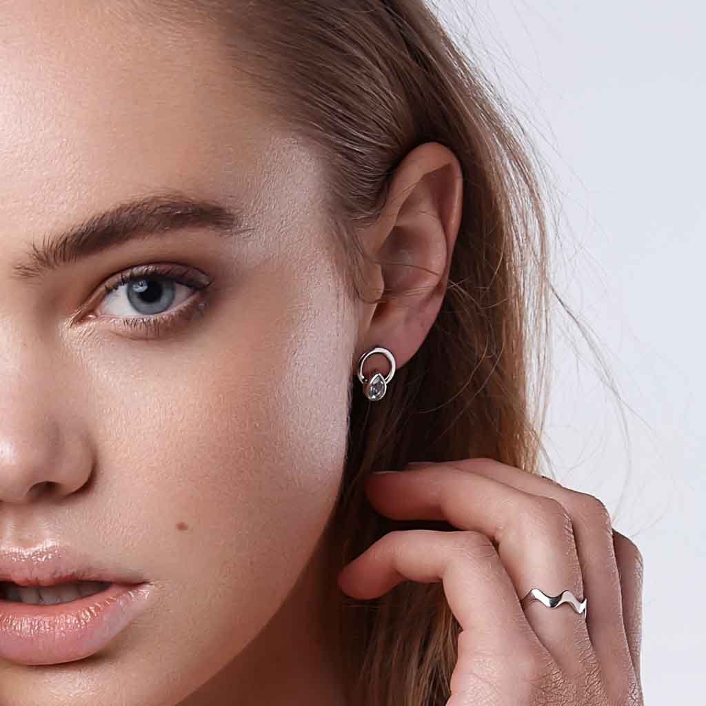 Model wearing Teardrop single ray earrings silver clear quartz 