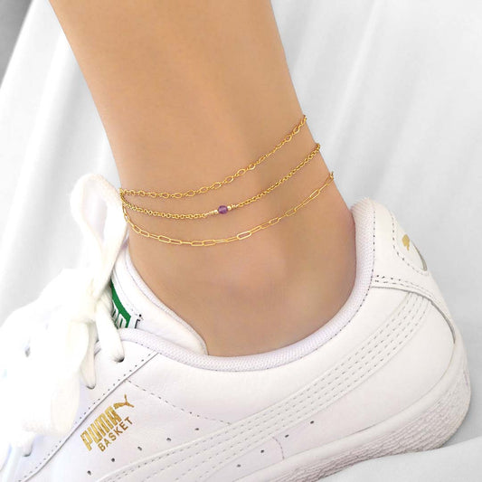 Model wearing 3 anklets layered