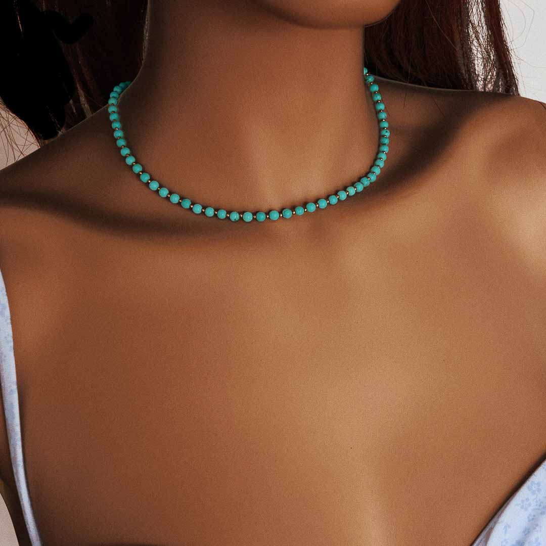 Model wearing Nefertiti necklace gold turquoise
