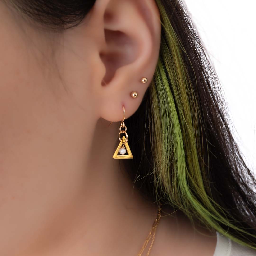 Model wearing triangle chime earrings