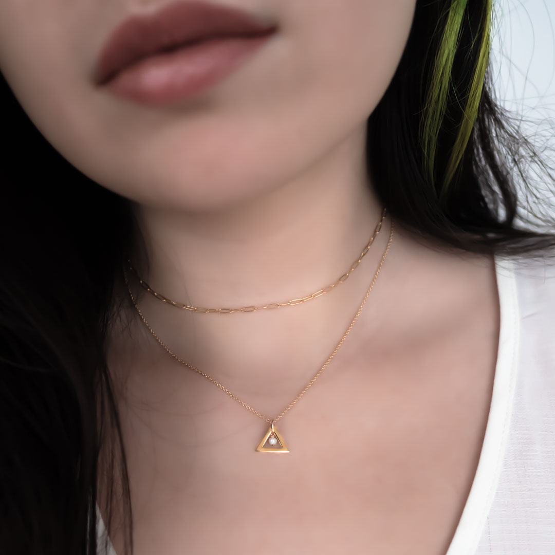 Model wearing triangle chime necklace