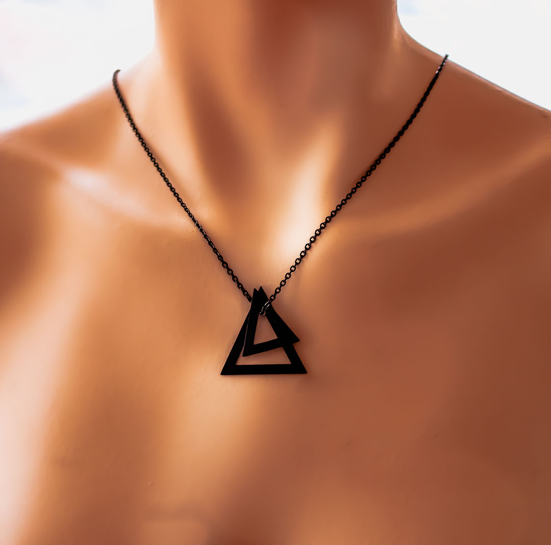 Model wearing double deltaglyph pendant black