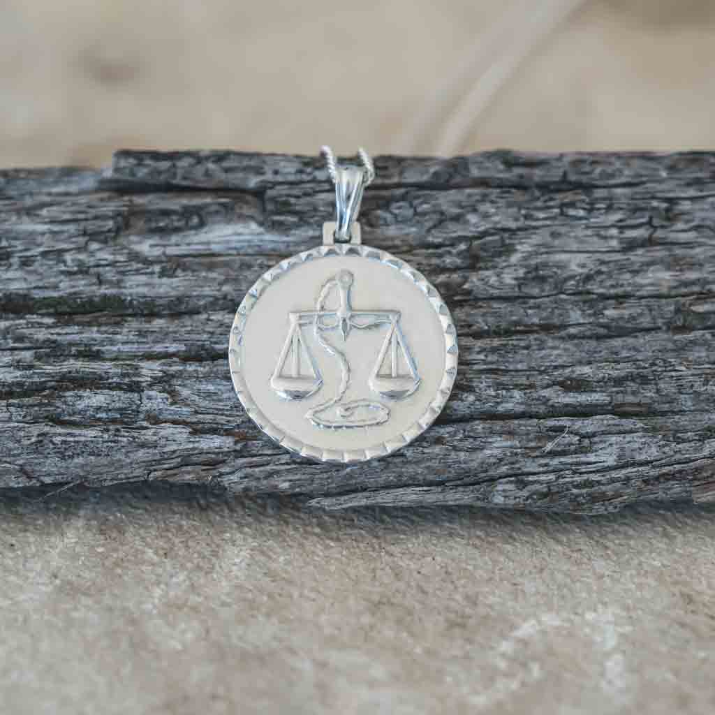 Libra star sign necklace pendant sterling silver jewellery on wood flatlay