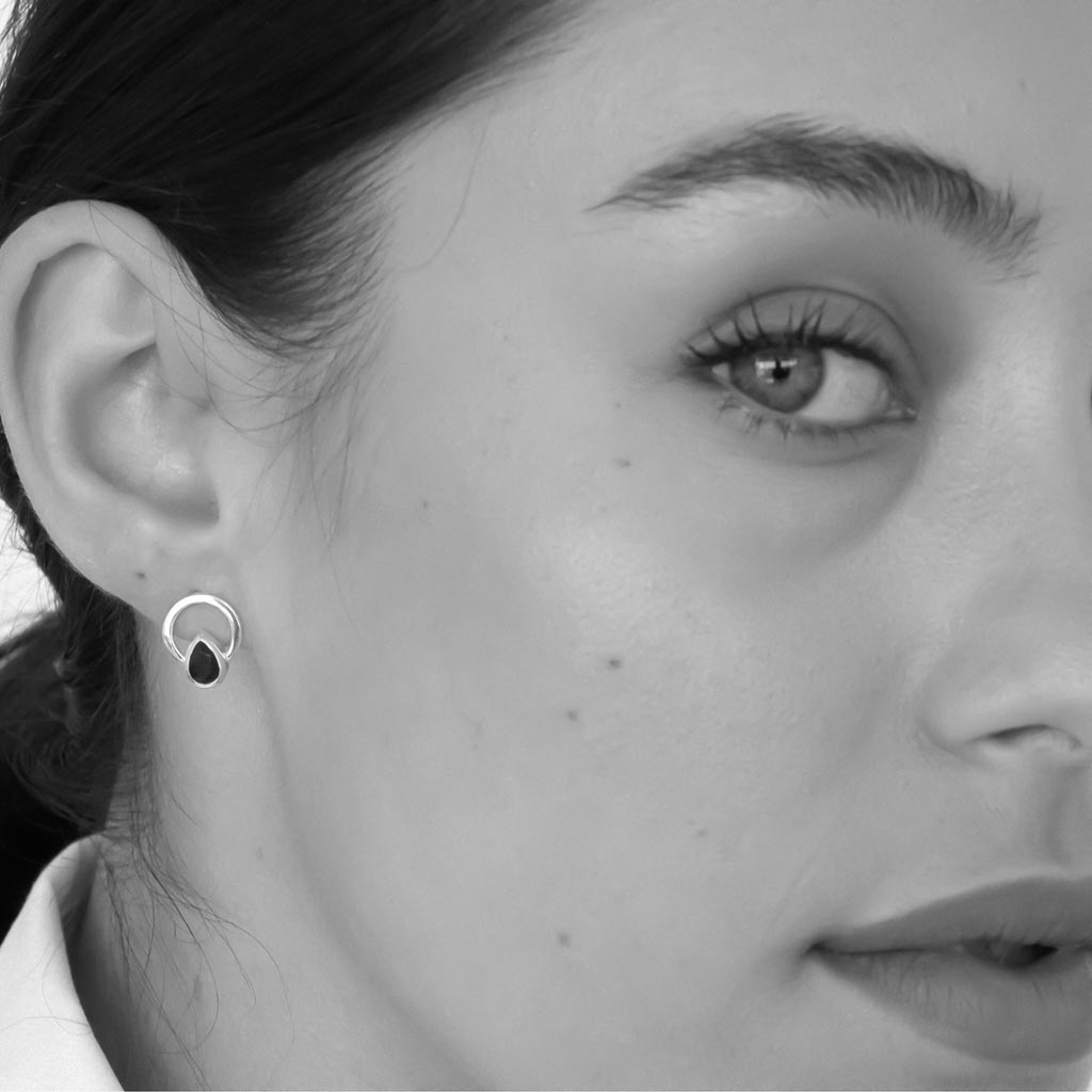 model wearing Teardrop single ray earrings sterling silver black spinel