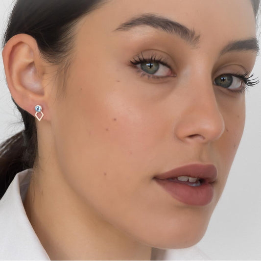 model wearing jaeger earring silver swiss blue topaz