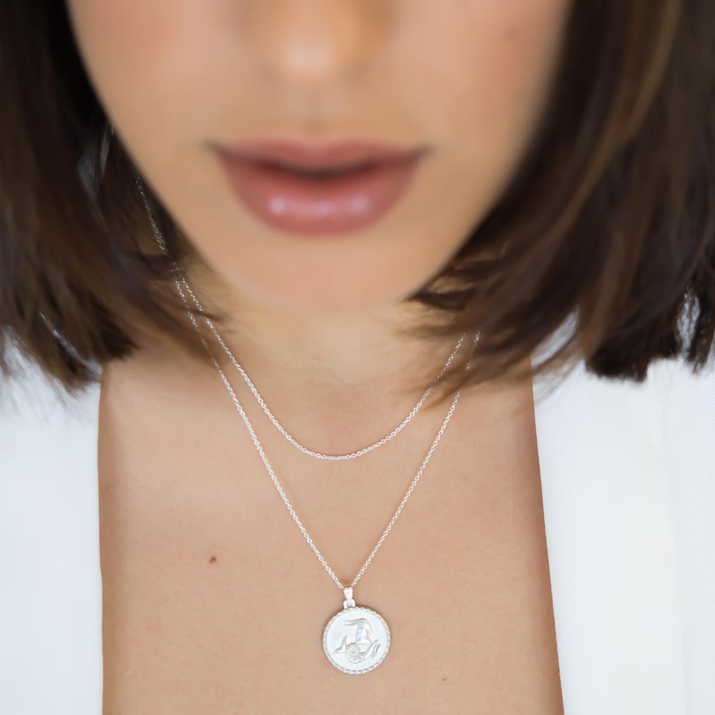 model wearing the capricorn star sign necklace pendant in sterling silver jewellery