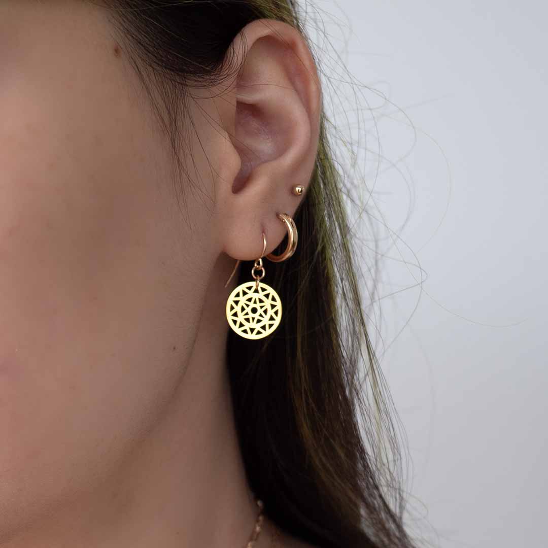 model wearing dandelion hook earings gold layered