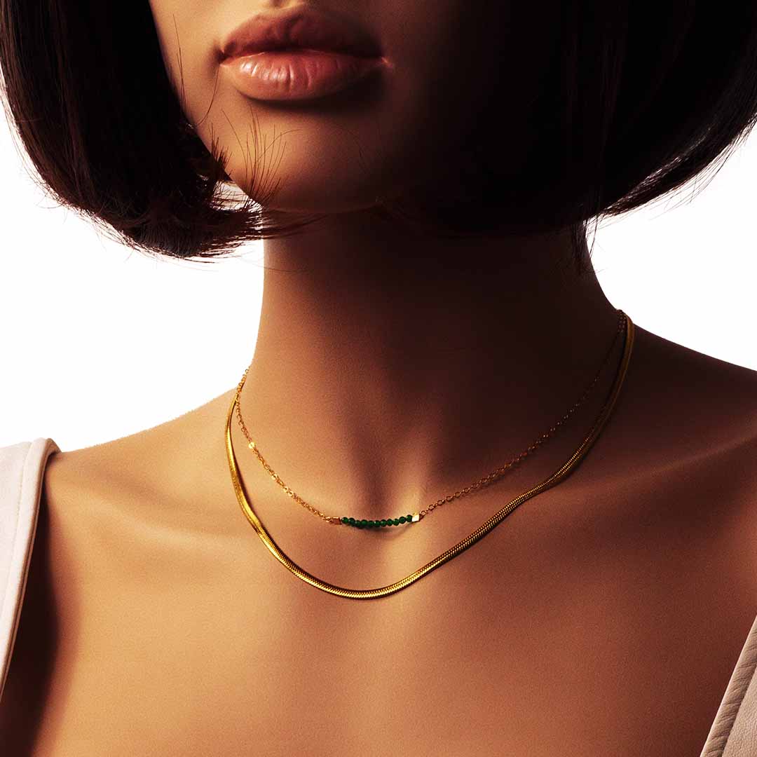 model wearing eden necklace gold emerald and medusa