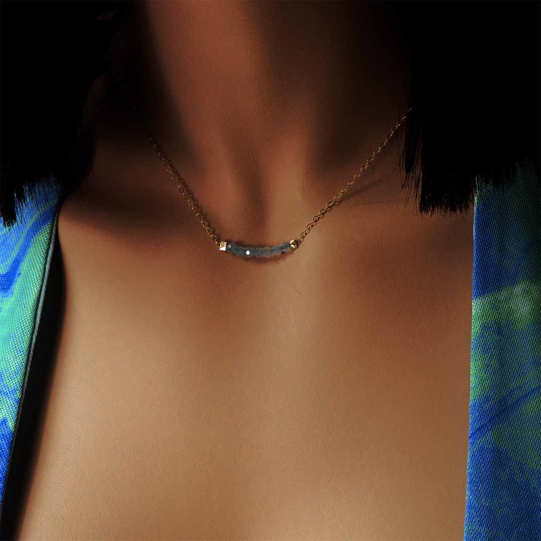 model wearing eden necklace gold aquamarine