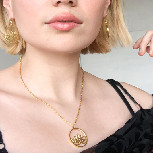 model wearing lotus necklace gold
