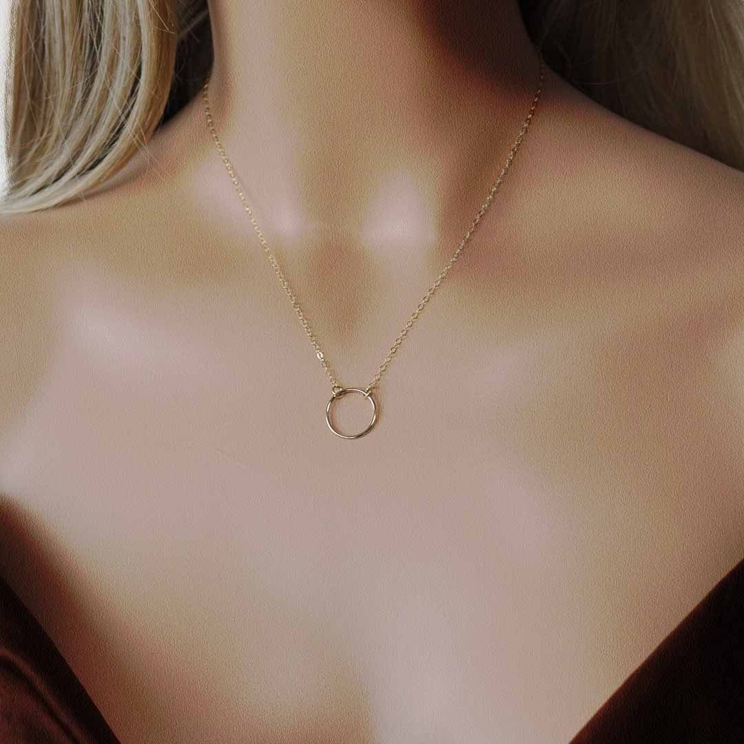 model wearing ring necklace gold