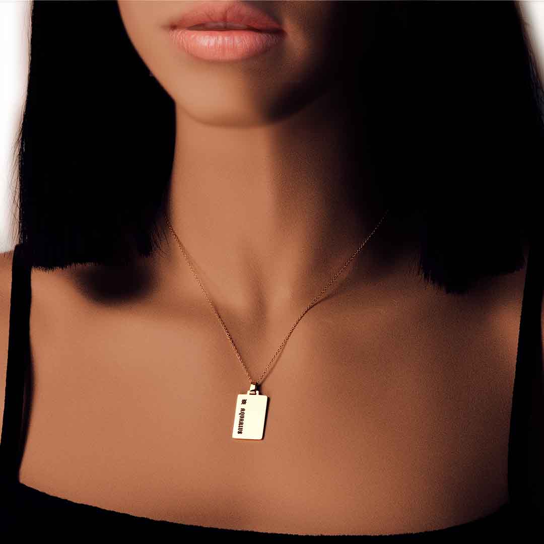 model wearing star sign necklace aquarius gold